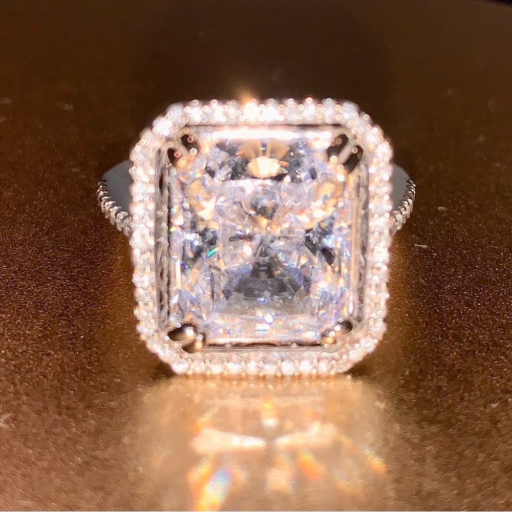 14K white gold custom made ring with diamond halo and band, and CZ center stone.